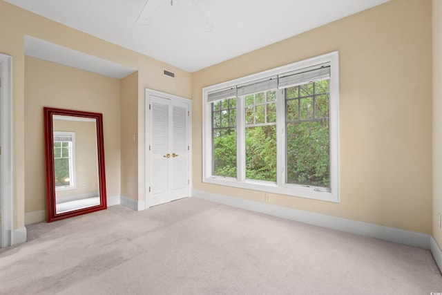carpeted spare room featuring baseboards
