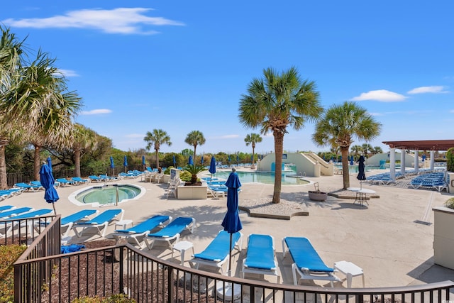 community pool featuring a jacuzzi and a patio area