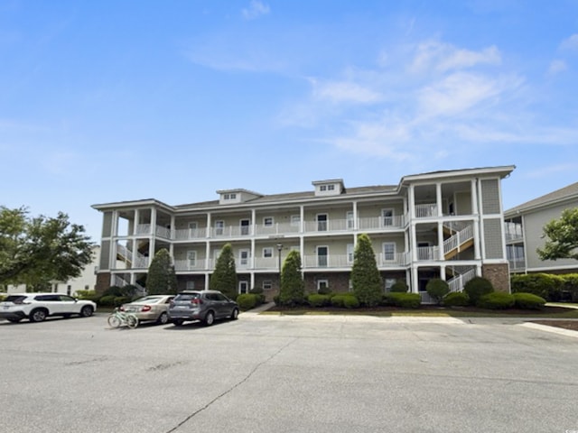 view of property featuring uncovered parking