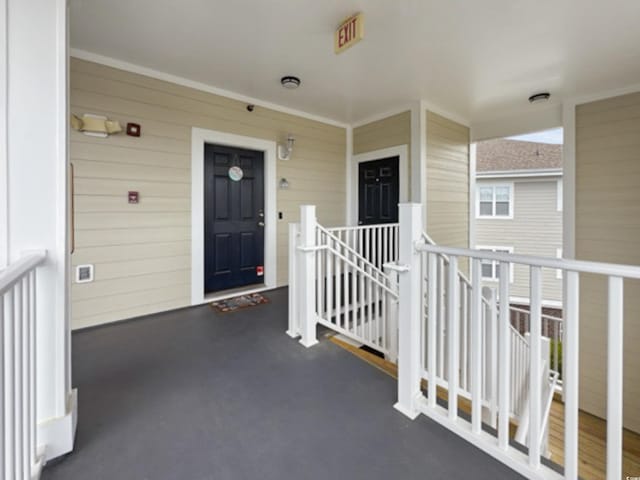 view of exterior entry with covered porch