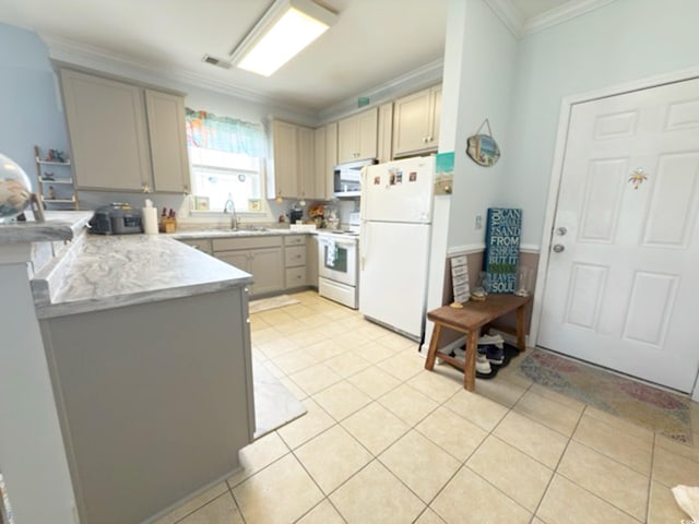 kitchen featuring crown molding, a peninsula, white appliances, light countertops, and a sink