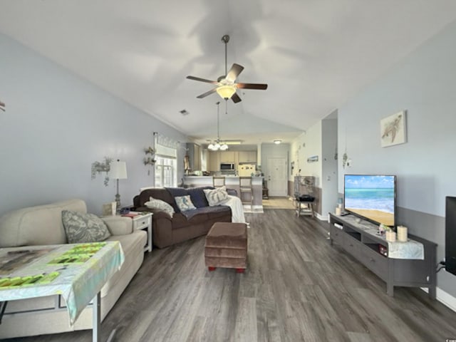 living room with ceiling fan, lofted ceiling, and dark wood-type flooring
