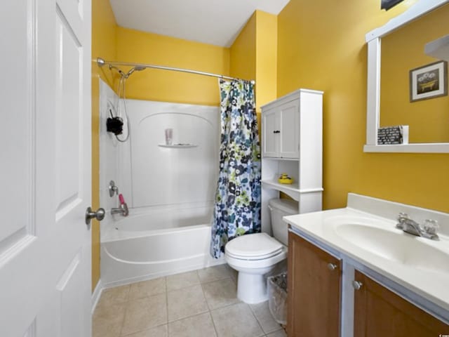 bathroom with vanity, tile patterned floors, toilet, and shower / bath combo with shower curtain