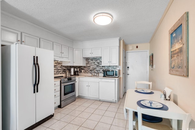 6302 N Ocean Blvd Unit G-3, North Myrtle Beach, SC 29582 - kitchen featuring a textured ceiling, tasteful backsplash, a sink, under cabinet range hood, and stainless steel appliances