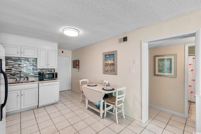 6302 N Ocean Blvd Unit G-3, North Myrtle Beach, SC 29582 - kitchen with white dishwasher, a sink, white cabinetry, stainless steel microwave, and visible vents