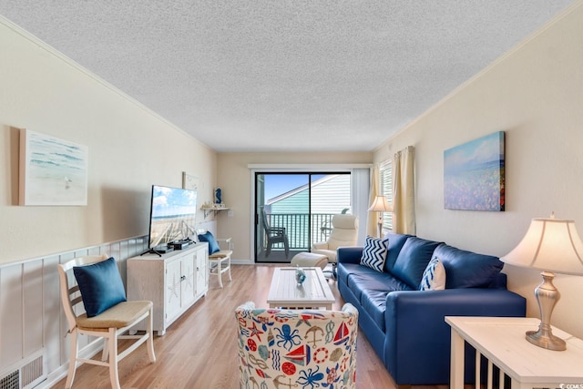 6302 N Ocean Blvd Unit G-3, North Myrtle Beach, SC 29582 - living room with ornamental molding, light wood finished floors, a textured ceiling, and visible vents