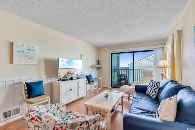 6302 N Ocean Blvd Unit G-3, North Myrtle Beach, SC 29582 - living area featuring a textured ceiling, visible vents, and light wood-style flooring