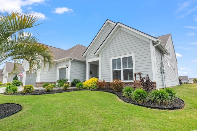 single story home featuring a garage, brick siding, and a front yard