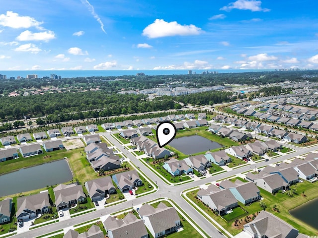 birds eye view of property featuring a water view, a city view, and a residential view