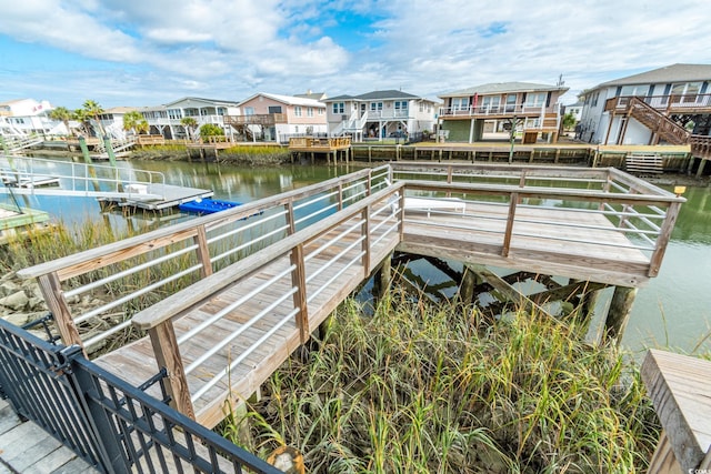 dock with a residential view and a water view