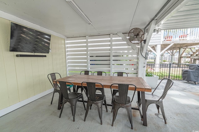 dining space featuring concrete flooring and baseboards