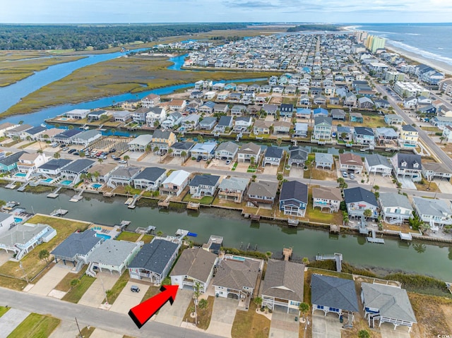 view of property location with a nearby body of water and nearby suburban area