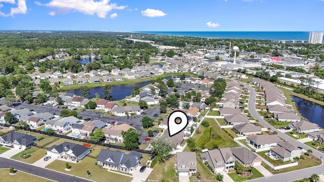 drone / aerial view with a water view and a residential view