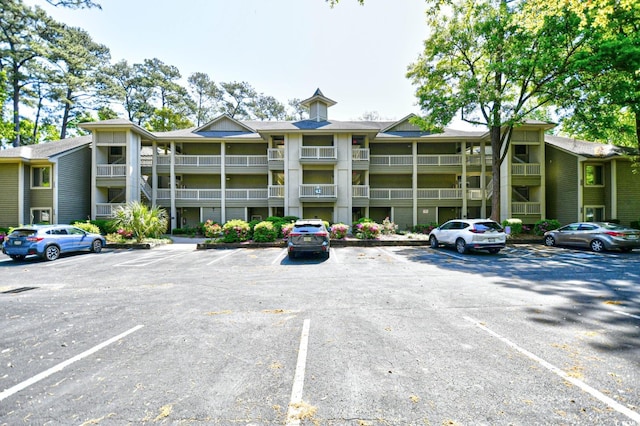 view of building exterior with uncovered parking