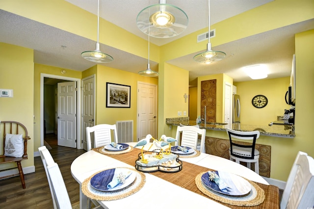 dining space featuring baseboards, visible vents, and dark wood-type flooring