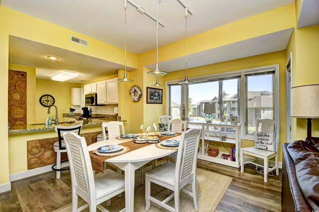 1401 Lighthouse Dr Unit 4226, North Myrtle Beach, SC 29582 - dining room featuring dark wood-style flooring, a textured ceiling, and visible vents