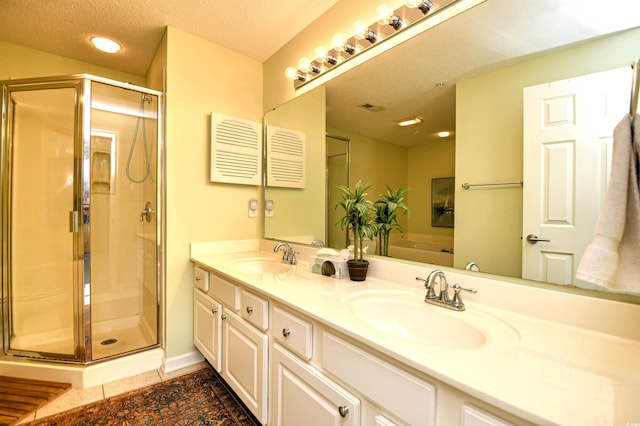 full bathroom featuring a sink, a shower stall, recessed lighting, and double vanity