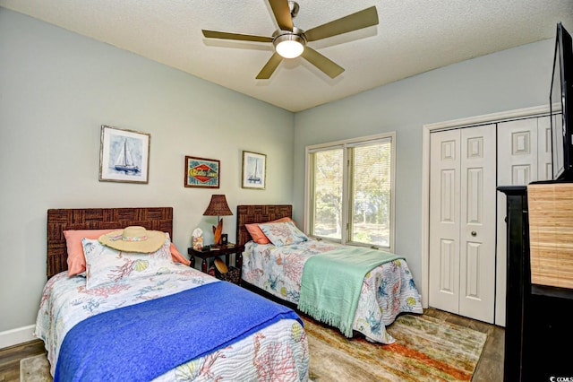 bedroom featuring a closet, a textured ceiling, ceiling fan, and wood finished floors