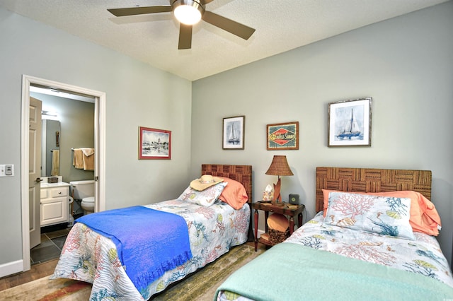 bedroom with connected bathroom, ceiling fan, and wood finished floors