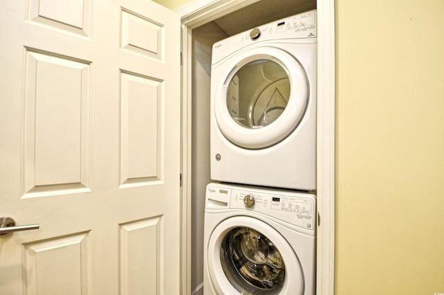 laundry area featuring stacked washer / drying machine and laundry area