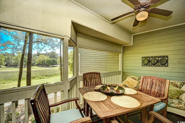 sunroom featuring a ceiling fan