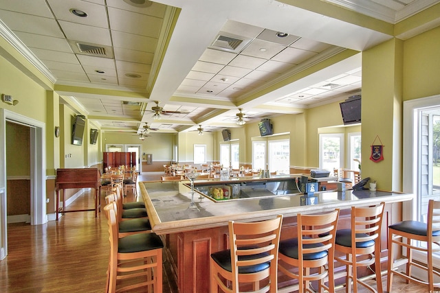kitchen with a ceiling fan, visible vents, beam ceiling, wood finished floors, and coffered ceiling