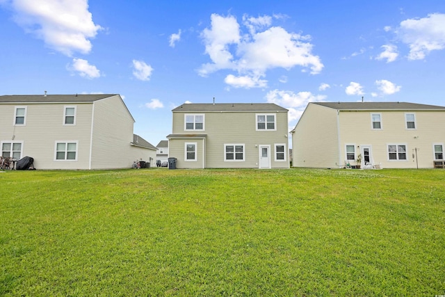 back of property featuring a yard
