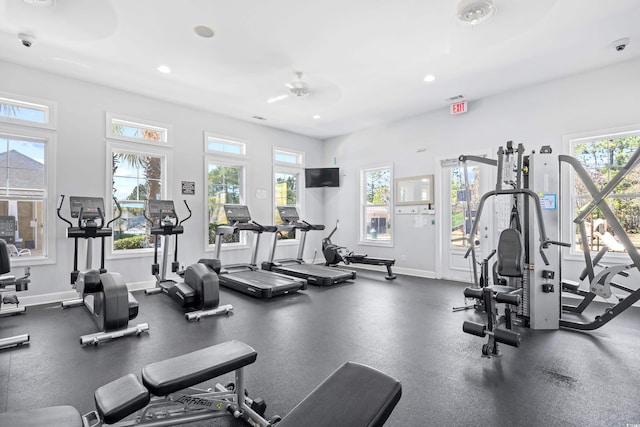 exercise room with baseboards, recessed lighting, and a wealth of natural light