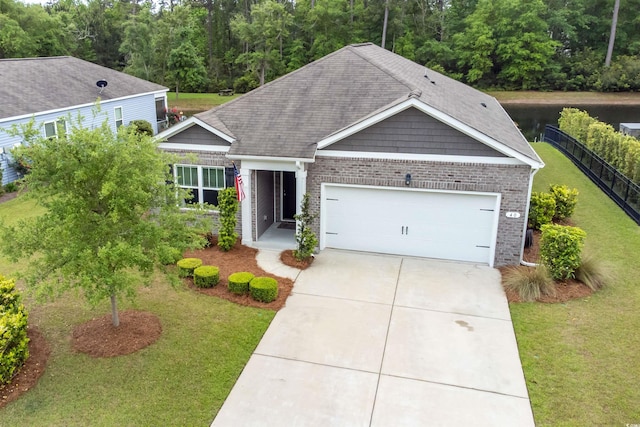 40 Parkside Dr, Pawleys Island, SC 29585 - view of front of house with brick siding, an attached garage, concrete driveway, and roof with shingles