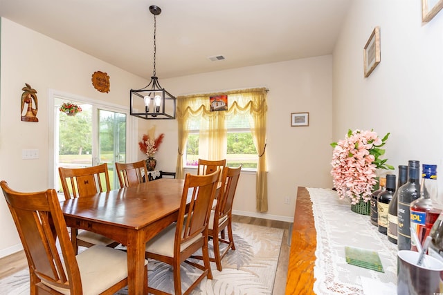 40 Parkside Dr, Pawleys Island, SC 29585 - dining area featuring light wood finished floors, a chandelier, and baseboards