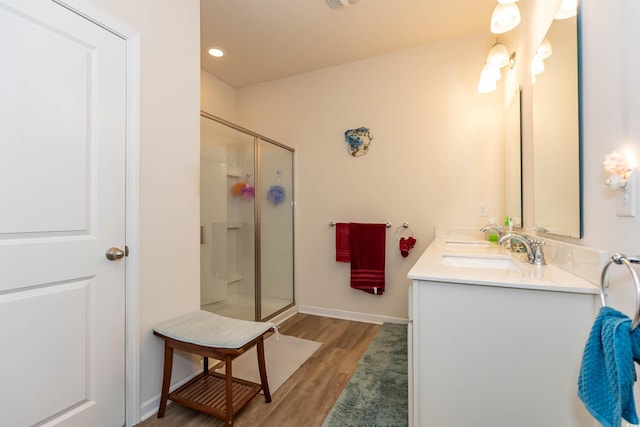 40 Parkside Dr, Pawleys Island, SC 29585 - bathroom with wood finished floors, a shower stall, baseboards, double vanity, and recessed lighting