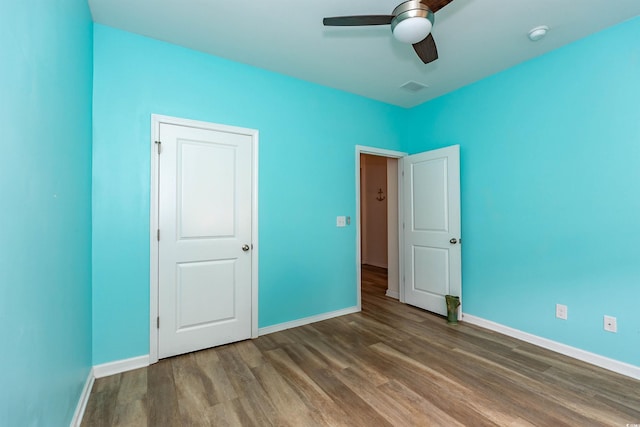 40 Parkside Dr, Pawleys Island, SC 29585 - unfurnished bedroom with wood finished floors, baseboards, and ceiling fan