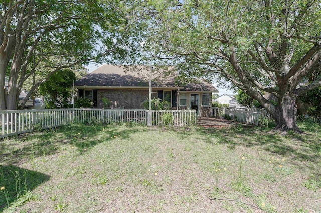 4300 Cross Cut Trl, Myrtle Beach, SC 29579 - back of house featuring a fenced backyard, a yard, and brick siding