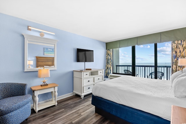 bedroom featuring dark wood-style flooring, access to outside, and baseboards