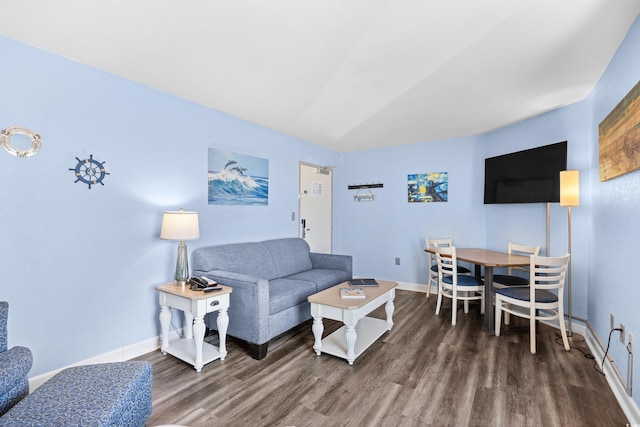 living area featuring baseboards and wood finished floors