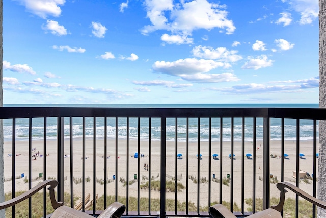 balcony featuring a beach view and a water view