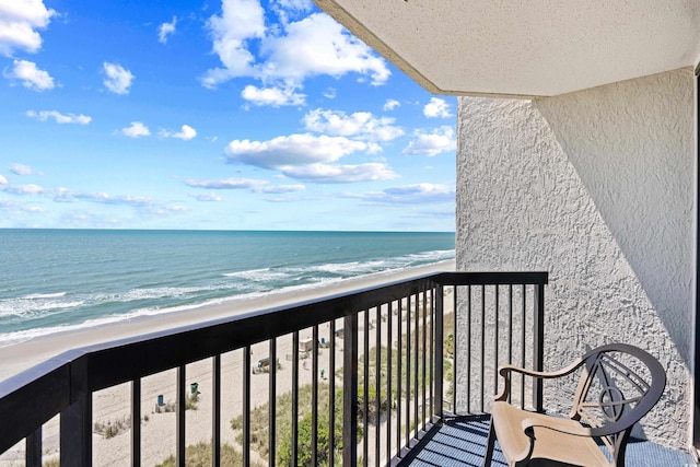 balcony with a beach view and a water view