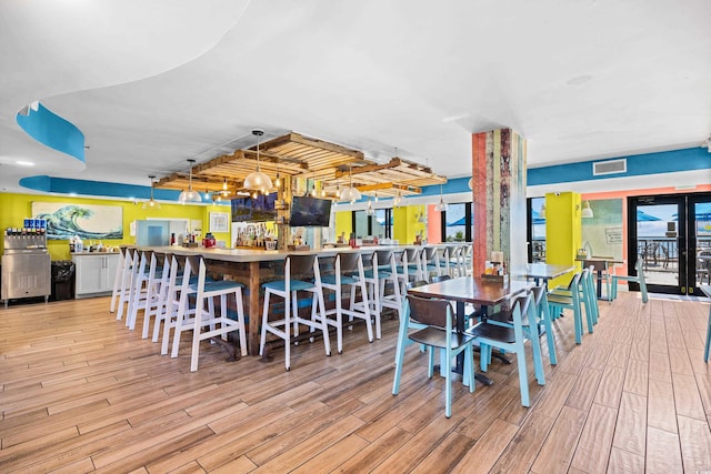 dining space with visible vents and light wood-style floors