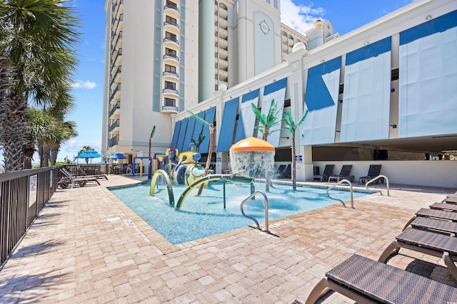 view of swimming pool featuring a water play area