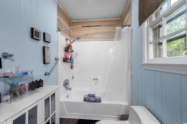 bathroom featuring toilet and shower / bathtub combination with curtain