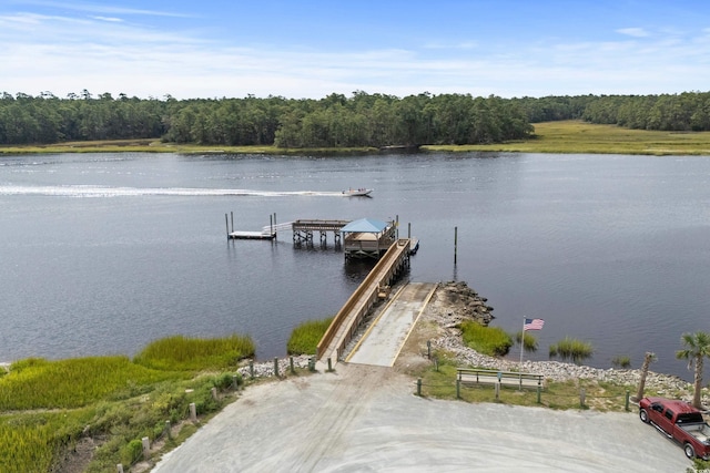 dock featuring a water view and a forest view