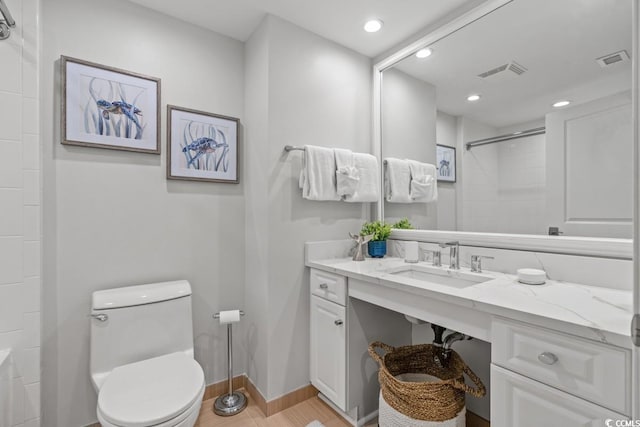 bathroom featuring a shower, toilet, vanity, recessed lighting, and wood finished floors