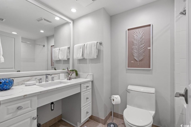 bathroom featuring a shower, toilet, recessed lighting, baseboards, and vanity