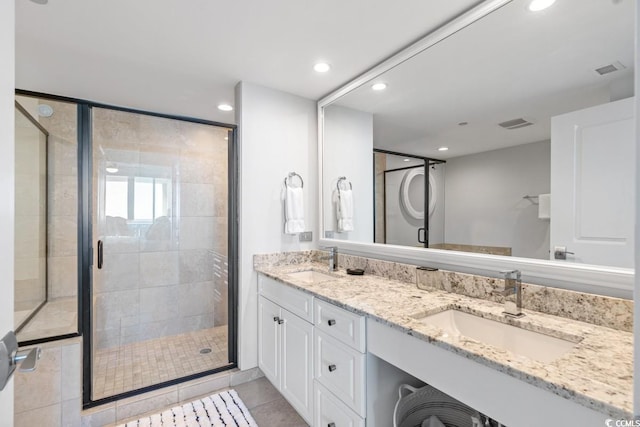 bathroom with a stall shower, recessed lighting, tile patterned floors, and double vanity