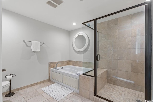 bathroom with a whirlpool tub, a stall shower, toilet, tile patterned flooring, and recessed lighting
