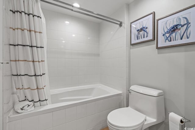 full bath with tiled shower / bath combo and toilet