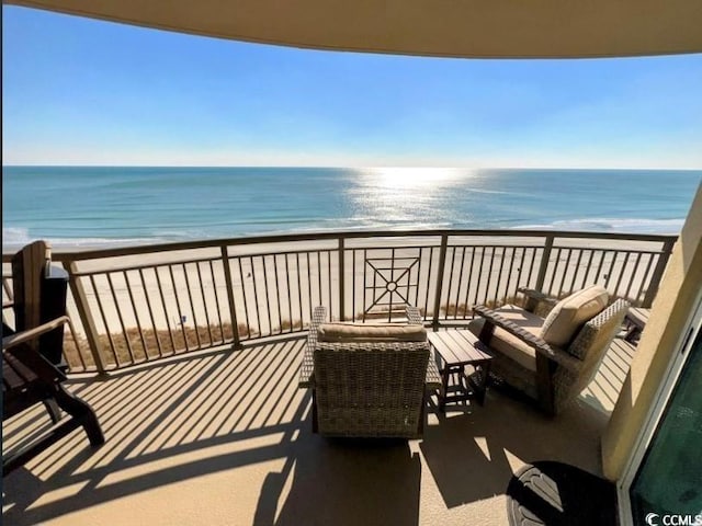 balcony with view of water and beach