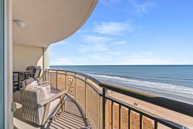 balcony with view of water and beach
