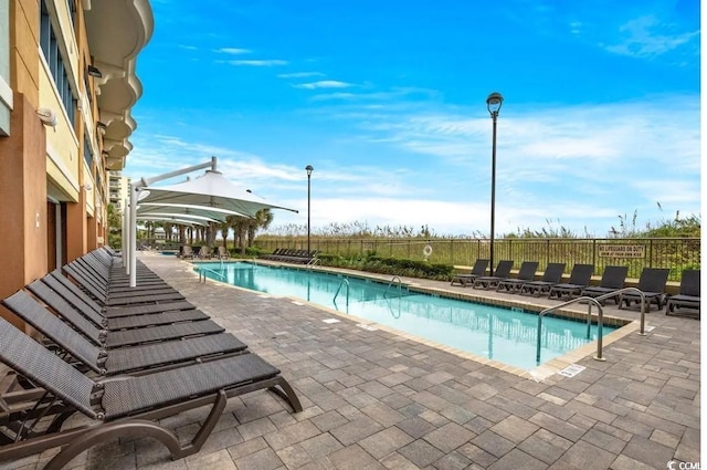 community pool with a patio area