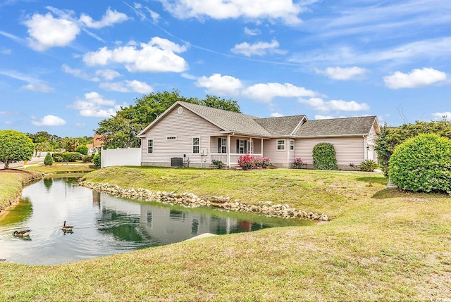 9616 Sullivan Dr, Murrells Inlet, SC 29576 - exterior space featuring covered porch, a front yard, a shingled roof, central AC unit, and a water view